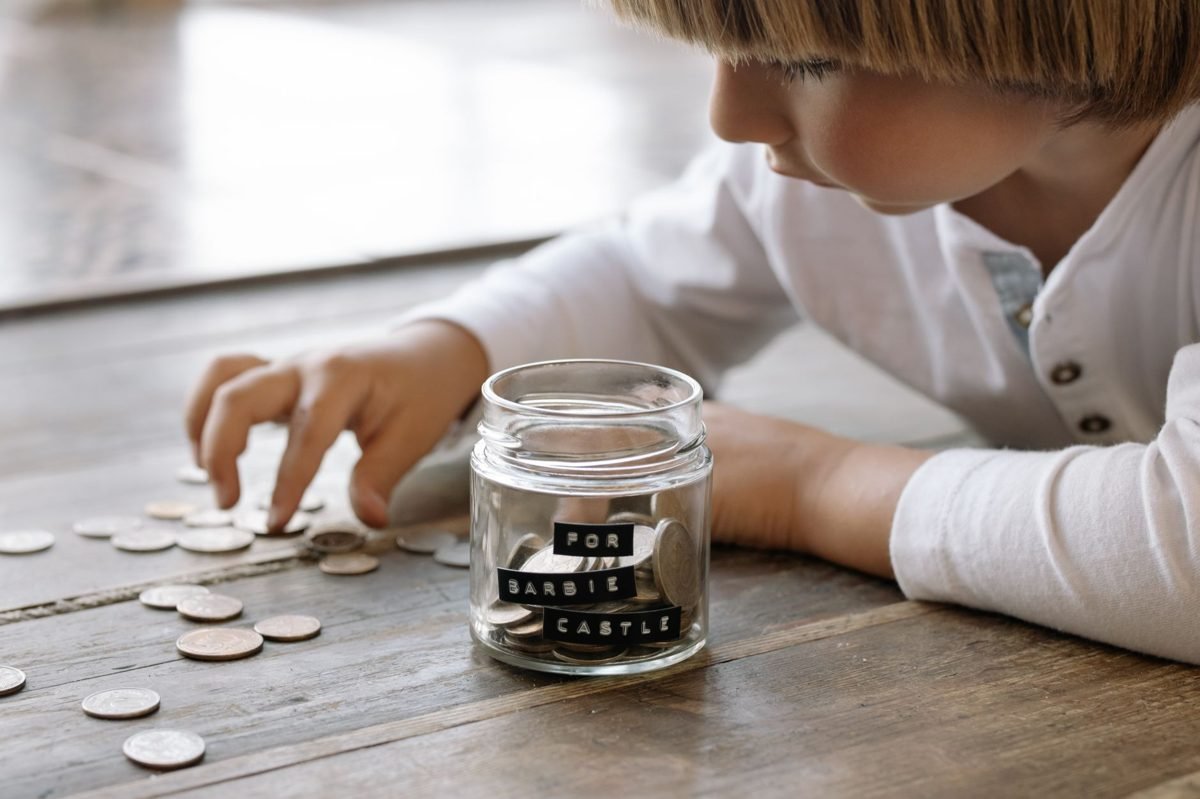 Growing stack of coins next to a small plant symbolizing compound investment growth over time