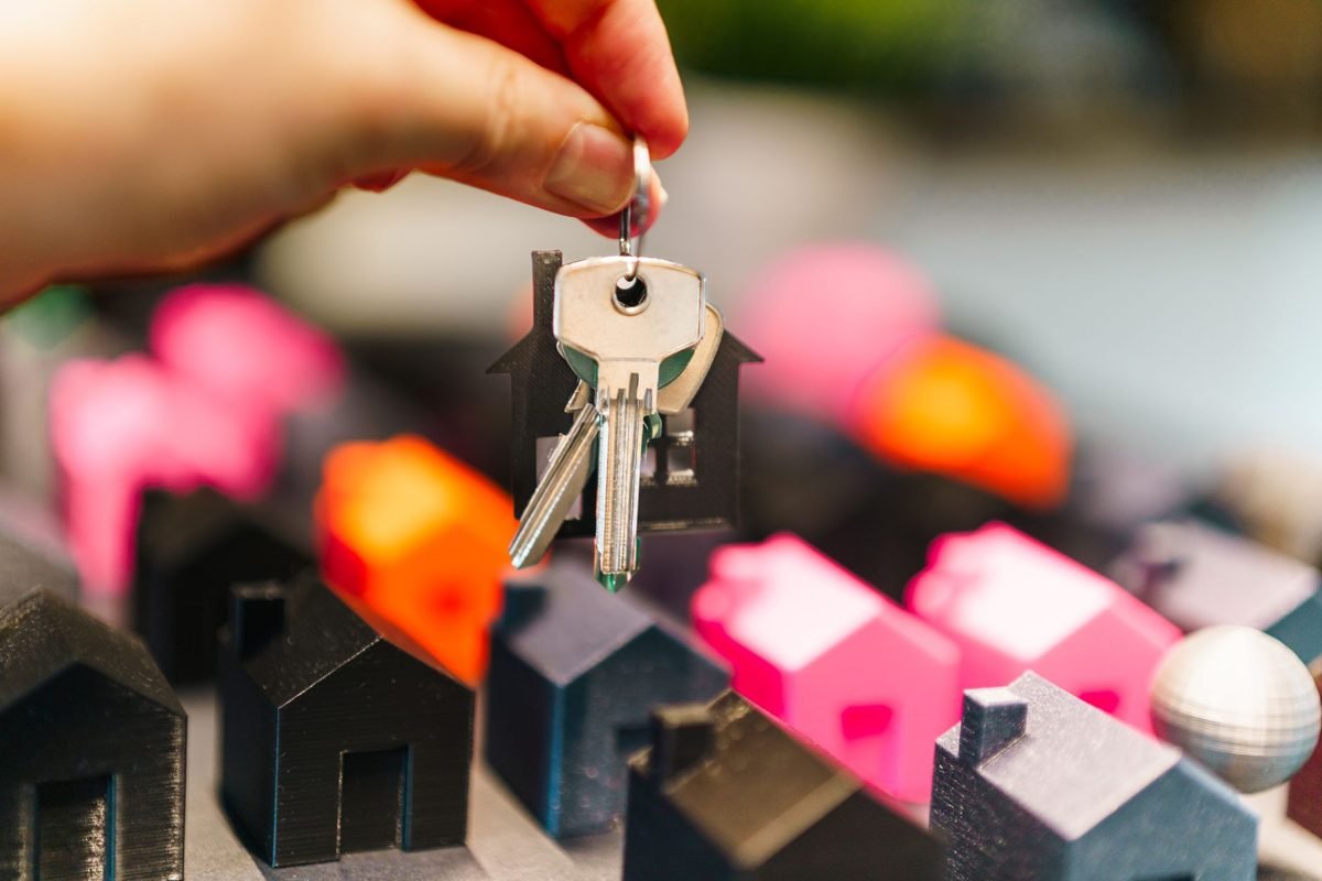Couple comparing a house for sale listing against a rental apartment listing